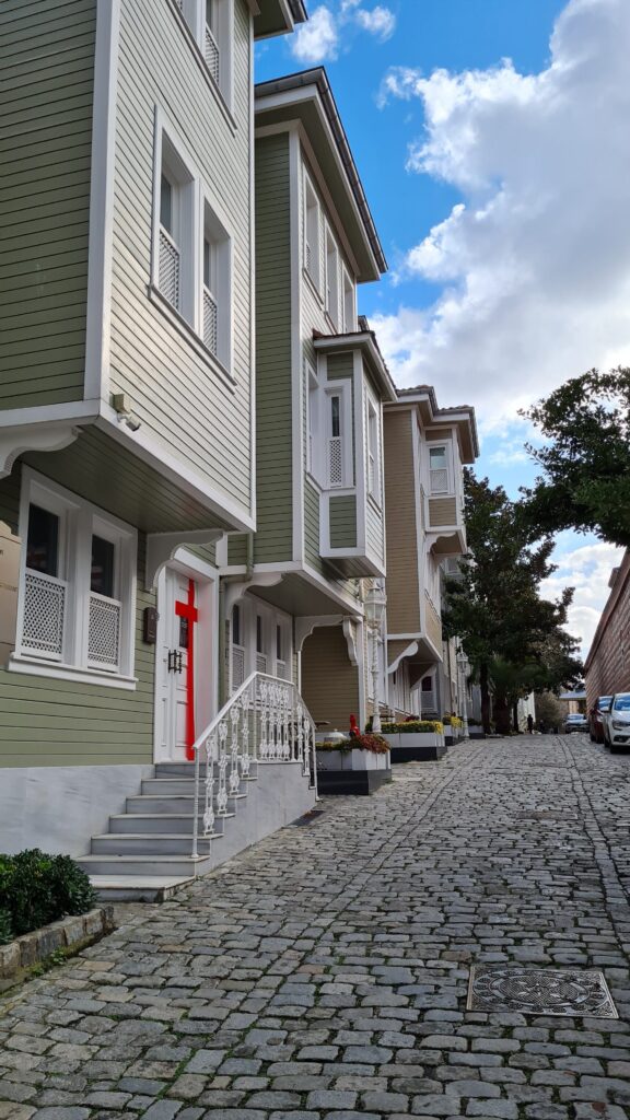 Charming historic street with cobblestone pavement and classic houses.