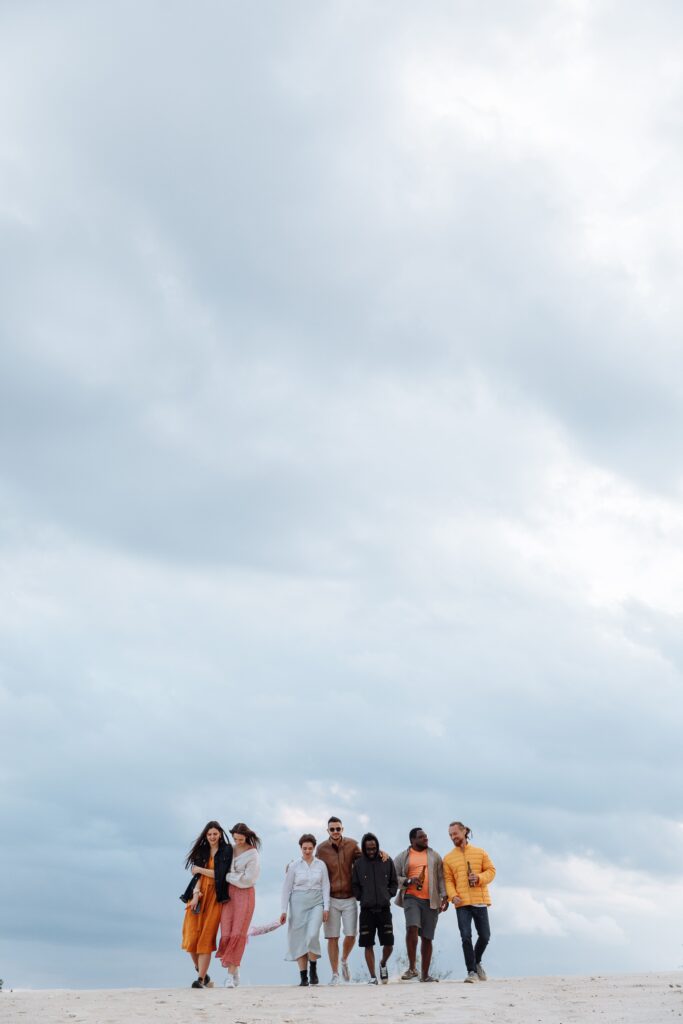 Top Gaming Laptops for Keyboard Performance and Comfort A diverse group of friends enjoys a walk on the beach under a dramatic cloudy sky.